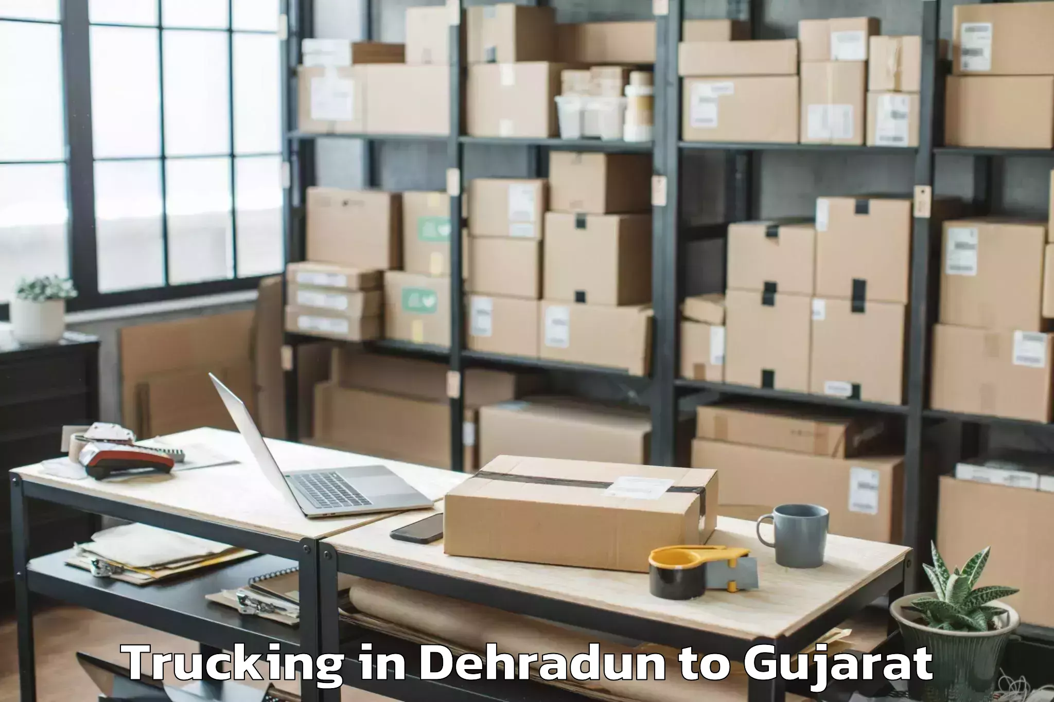 Book Dehradun to Gadhada Trucking